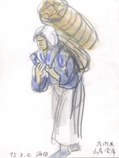 倉庫内に展示されている，米俵を運ぶ女性の模型．1995年8月2日作